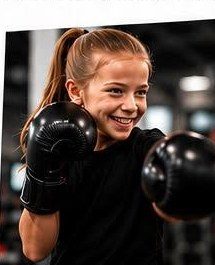 A smiling child wearing boxing gloves at BoxFit Kids